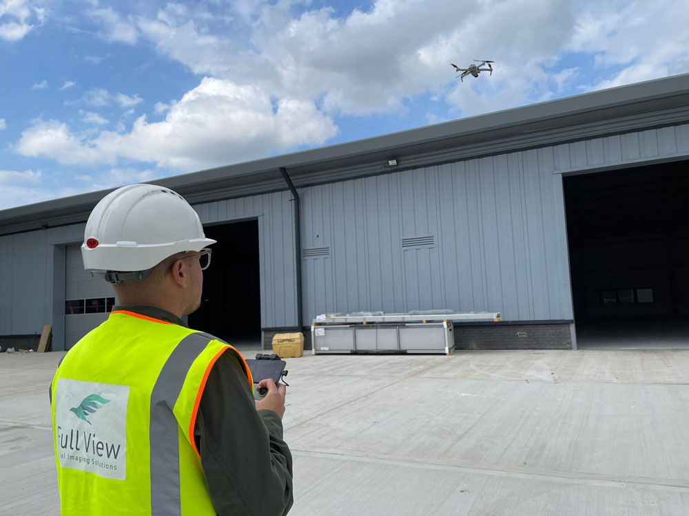 Person with reflective vest flying a drone